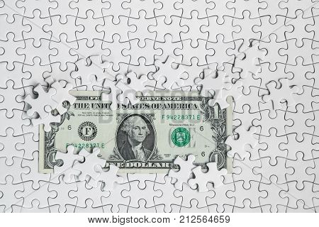 Missing jigsaw puzzle pieces on money dollar background Business solution concept key for success