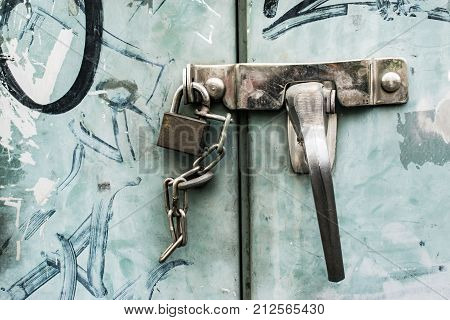 old steel cabinet locked by latch and chain
