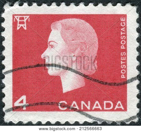 CANADA - CIRCA 1963: Postage stamp printed in Canada shows portrait of Queen Elizabeth II and Electric high tension tower circa 1963