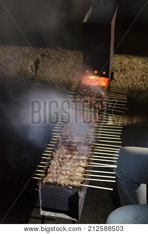 View of arrosticini baking on the fire