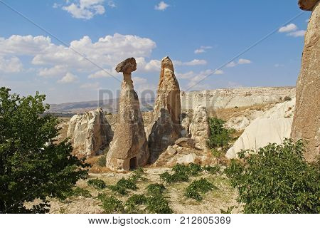 Natural valley with volcanic tuff stone rocks dramatically lit by a sun in Chavushin in Cappadocia Central Anatolia region of Turkey. Popular tourist destination in Turkey for trekking.