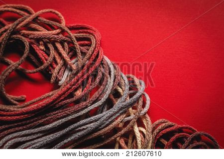 colorful sewing threads on a  red background