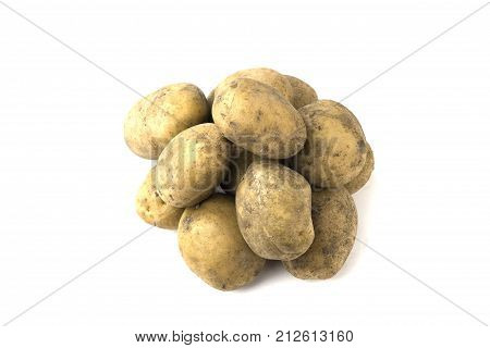 Pile of raw potatoes on a white background. Tubers of fresh, dirty potatoes close-up