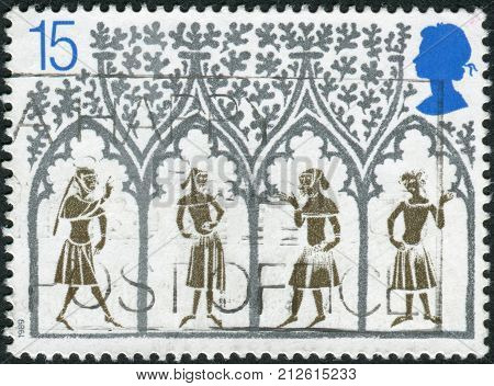 UNITED KINGDOM - CIRCA 1989: Postage stamp printed in England is dedicated to 800th Anniversary of Ely Cathedral shows a 14th Century Peasants from Stained-glass Window circa 1989