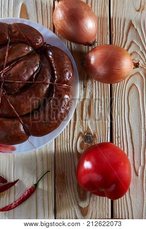 Kitchen table on the table: smoked sausage tomato and hot pepper to strengthen the apetite.