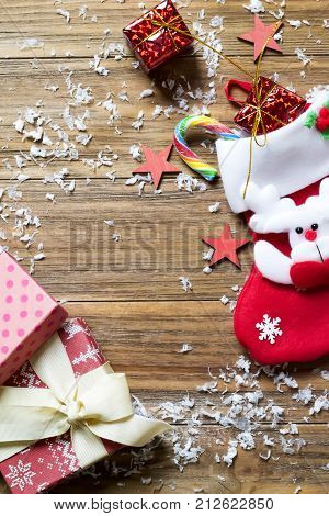 Christmas background with decorations and gift boxes on wooden board flat lay copy space