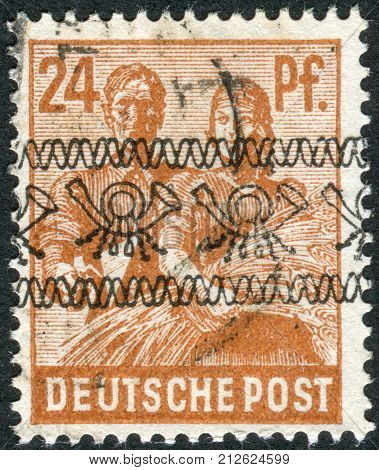 GERMANY - CIRCA 1947: Postage stamp printed in Germany (overpint Type A: US and British occupation zone) shows the Reaping Wheat circa 1947