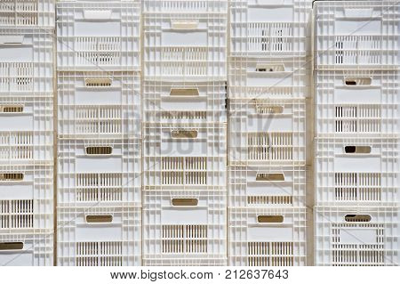 Background of white plastic boxes stacked in stock