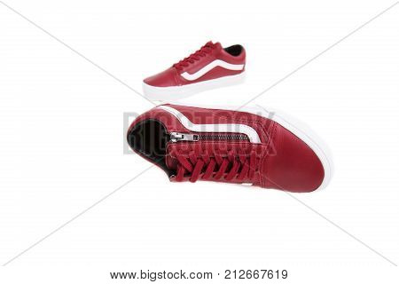 Fashion shoes with shoestring. Red sneaker and shoelace isolated on white background