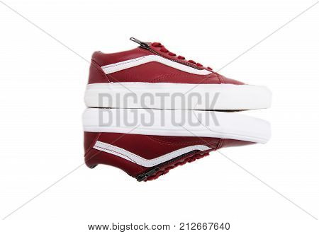 Fashion shoes with shoestring. Red sneaker and shoelace isolated on white background
