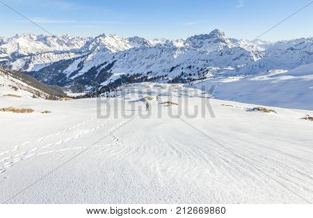 Mature couple hiking with snowshoes in winter mountain landscape. Alps, Germany, Bavaria, Allgau.