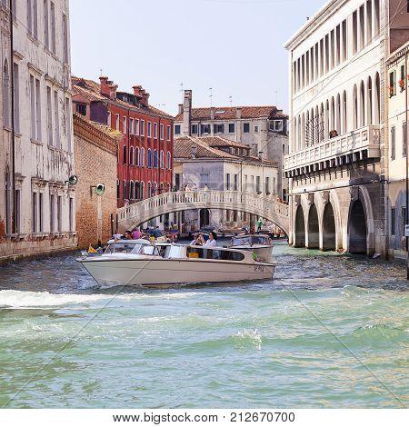 VENICE ITALY - SEPTEMBER 22 2017: City tour by tourists with cruise shipside channel.Communication in the city is done by water which creates a network of 150 channels interconnected.