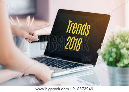 Trends 2018 On Laptop Screen With Business People Meeting In Front Of Computer Screen On Desk At Off