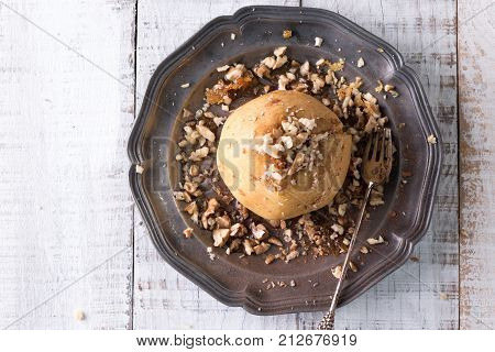 Baked Apples Stuffed With Raisins, Walnuts And Honey On A Plate