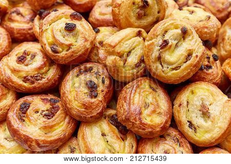 puff cakes with raisins on a plate close up