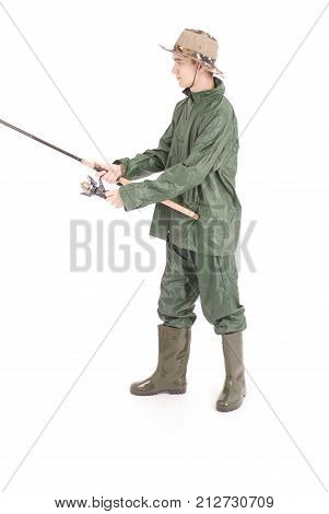 A full length portrait of a young happy fisherman holding a fishing pole isolated against white background