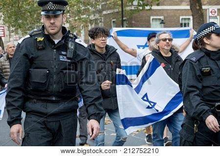 4th November 2017 London United Kingdom:-Police officers march infron of Pro Israeli protestors to keep pro Palestine protesters away