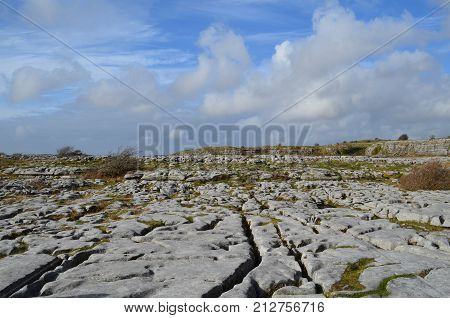 The countryside of Burren with blue cloudy skies with rocky land