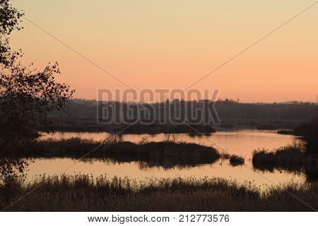 Landscape at sunset in the ponds of the Torbiere at the border of Lake Iseo in Brescia - Italy