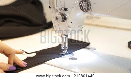 Sewing machine, seamstress sewing at machine and women's hands. Antique Sewing Machine Franklin. Young Woman Wears Protective Face Mask Working On Sewing Machine. Fashion HD