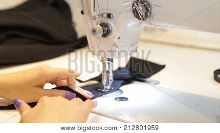 Sewing machine, seamstress sewing at machine and women's hands. Antique Sewing Machine Franklin. Young Woman Wears Protective Face Mask Working On Sewing Machine. Fashion HD