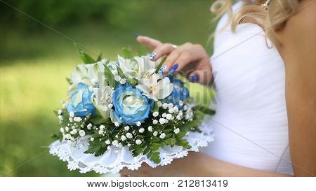 Beautiful bouquet of different colors in the hands of the bride in a white dress. Bride in white dress with bouquet Black woman holds wedding bouquet. Wedding HD