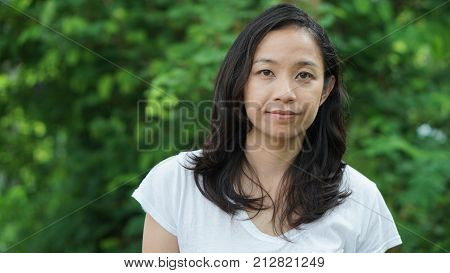 Asian Woman Long Hair With Facial Epression Green Nature Background