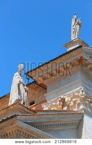 Urbino, Italy - August 9, 2017: The Cathedral. Piazza Duca Federico. Sculpture And Statue In Archite