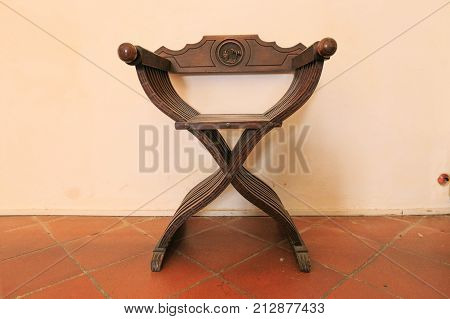Urbino Italy - August 9 2017: The Castle of the Dukes of Urbino. Ancient chair in the interior