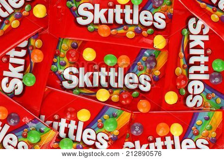 Kiev Ukraine - September 27 2017: Skittles multicolored fruit candies packages background. Skittles is a brand of fruit-flavoured sweets currently produced and marketed by the Wrigley Company