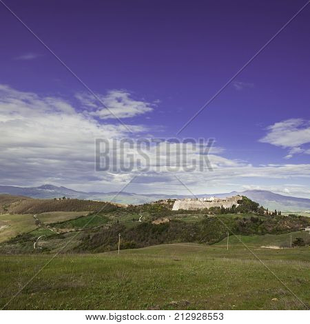 Village Trevinano located upon a hill near the borders of Lazio with the Tuscany and Umbria. Italian landscape with forests and meadow early in the morning. Agriculture in Italy fields and pastures.