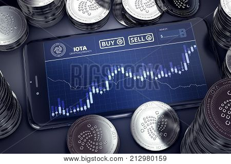 Smartphone with IOTA trading chart on-screen among piles of silver IOTA coins. IOTA trading concept. 3D rendering