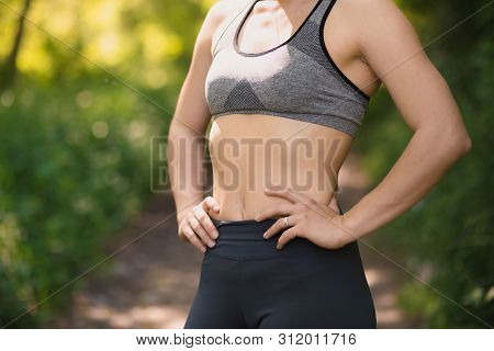 Female Trainer Showing Her Arm Muscels. Healthy, Active Lifestyle, Losing Weight. Women Power