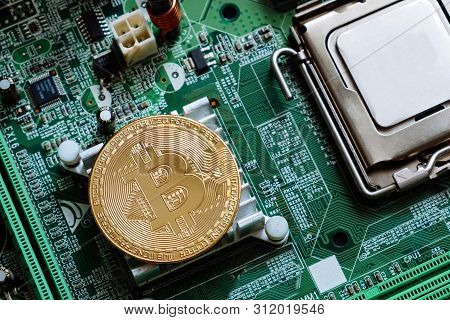 Golden Bitcoin On Computer Motheboard Flat Lay. Coin On Technology Laptop Detail Near Processor. Mod