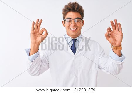 Young handsome sciencist man wearing glasses and coat over isolated white background relaxed and smiling with eyes closed doing meditation gesture with fingers. Yoga concept.