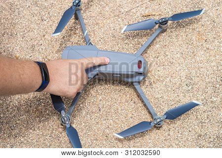 Male Hand Presses The Button To Launch The Drone For Flight, Close-up