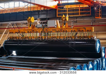 Coated Pipe Transportation By Overhead Crane With Vacuum Handling Grippers.