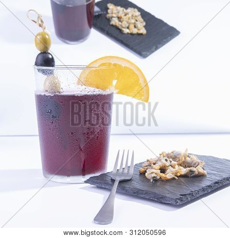 Vermouth Glass With Appetizers Such As Olives, And Mussels In A Mirror Reflection And With Backgroun
