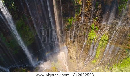 Beautiful Waterfall Coban Sewu In Tropical Forest, Java Indonesia. Aerial View Tumpak Sewu Waterfall