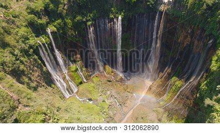 Beautiful Waterfall Coban Sewu In Tropical Forest, Java Indonesia. Aerial View Tumpak Sewu Waterfall