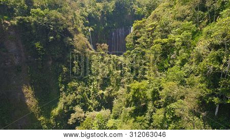 Aerial View Waterfall Coban Sewu In Java, Indonesia. Waterfall In Tropical Forest By Drone Tumpak Se