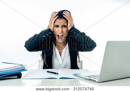 Desperate Beautiful Young Businesswoman Working On Her Laptop Going Crazy With Loads Of Work
