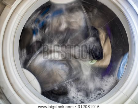 Top Loading Washing Machine Washes Laundry. Internal View Of A Washing Machine Drum During Wash. Top