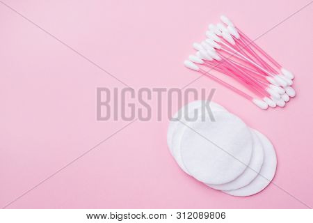 Pink Cotton Buds And Cotton Swabs On Pink Background. Selective Focus Copy Space.