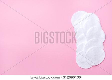 Cotton Round Swabs On A Pink Background. Selective Focus Copy Space.