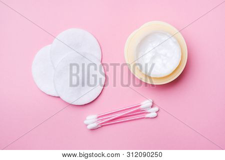 Pink Cotton Swabs And Cotton Swabs And A Can Of Cream On A Pink Background. Selective Focus Copy Spa