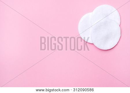 Cotton Round Swabs On A Pink Background. Selective Focus Copy Space.
