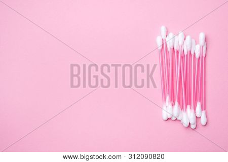 Pink Cotton Buds On Pink Background. Selective Focus Copy Space.