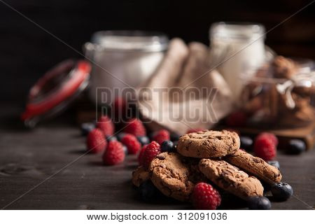 Rustic Wooden Table Full Of Delicious Chocolate Chips With Tasty Bluebarries