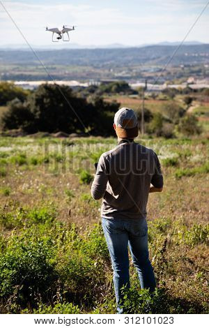 Man Playing With Drone On The Open Field